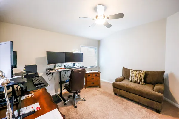 a view of a livingroom with workspace and a couch
