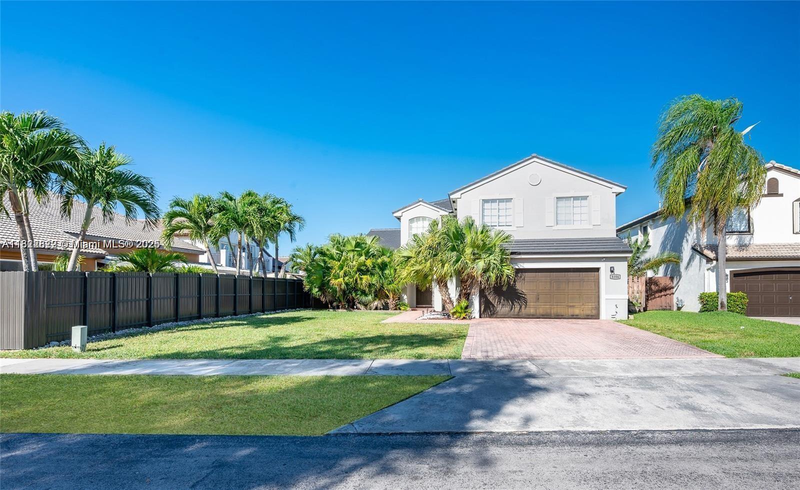 8356 Southwest 158th Avenue Miami, FL 33193 - Photo 1 of 48 a view of a house with a yard and palm trees
