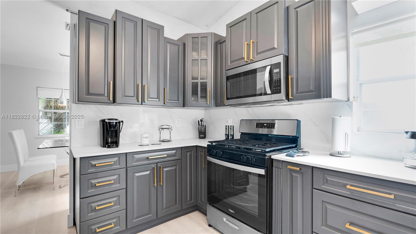 8356 Southwest 158th Avenue Miami, FL 33193 - Photo 12 of 48 a kitchen with stainless steel appliances granite countertop a stove microwave and cabinets