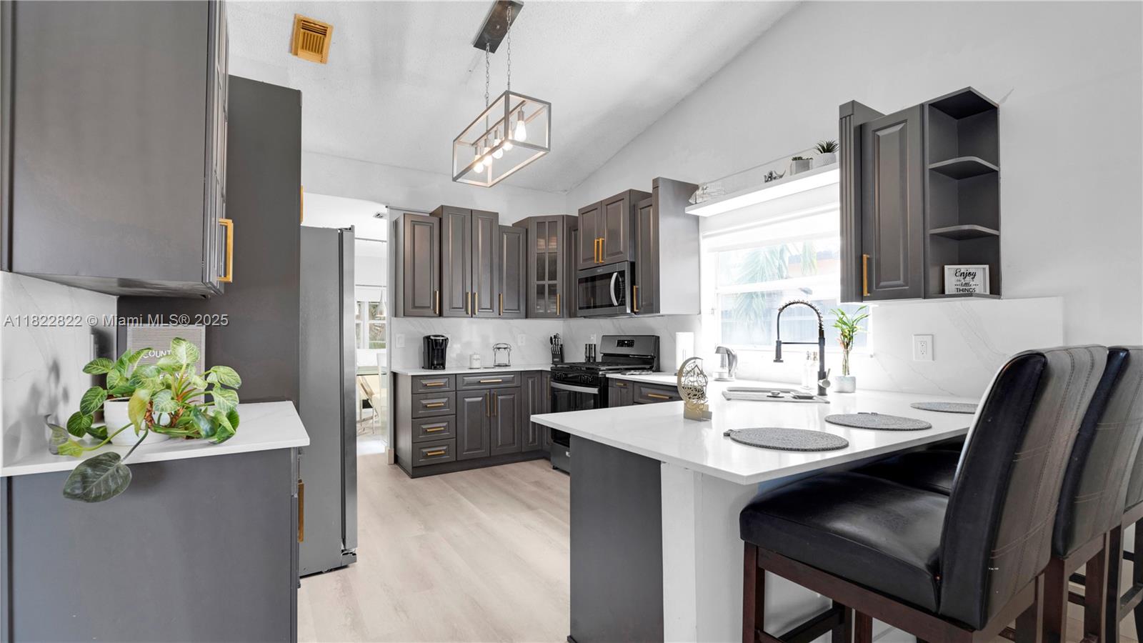 8356 Southwest 158th Avenue Miami, FL 33193 - Photo 17 of 48 a kitchen with a sink stainless steel appliances and cabinets