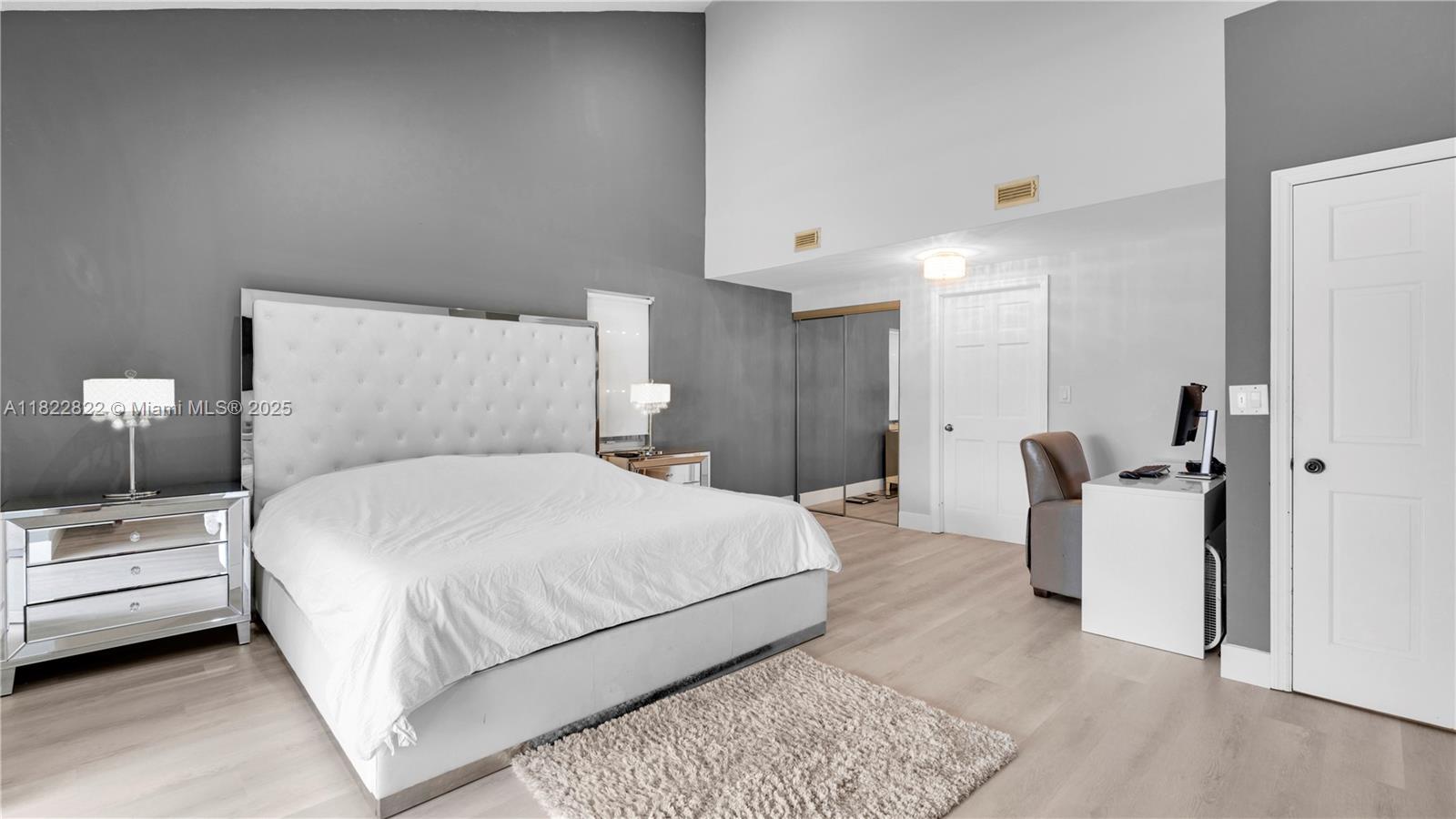 8356 Southwest 158th Avenue Miami, FL 33193 - Photo 22 of 48 a bedroom with a bed and a chandelier