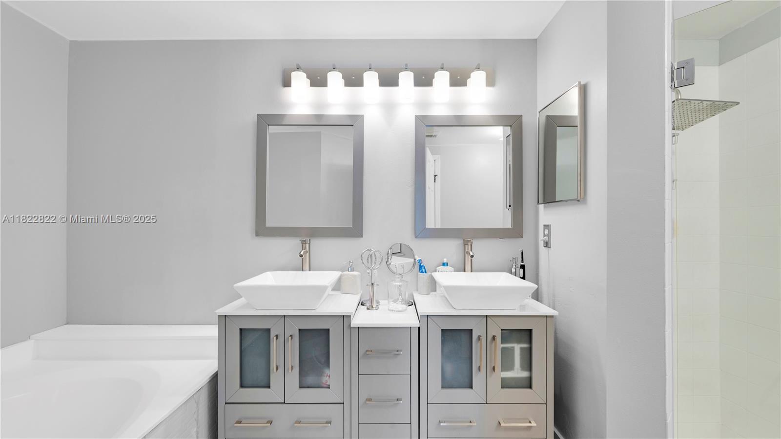 8356 Southwest 158th Avenue Miami, FL 33193 - Photo 23 of 48 a bathroom with a double vanity sink and a mirror