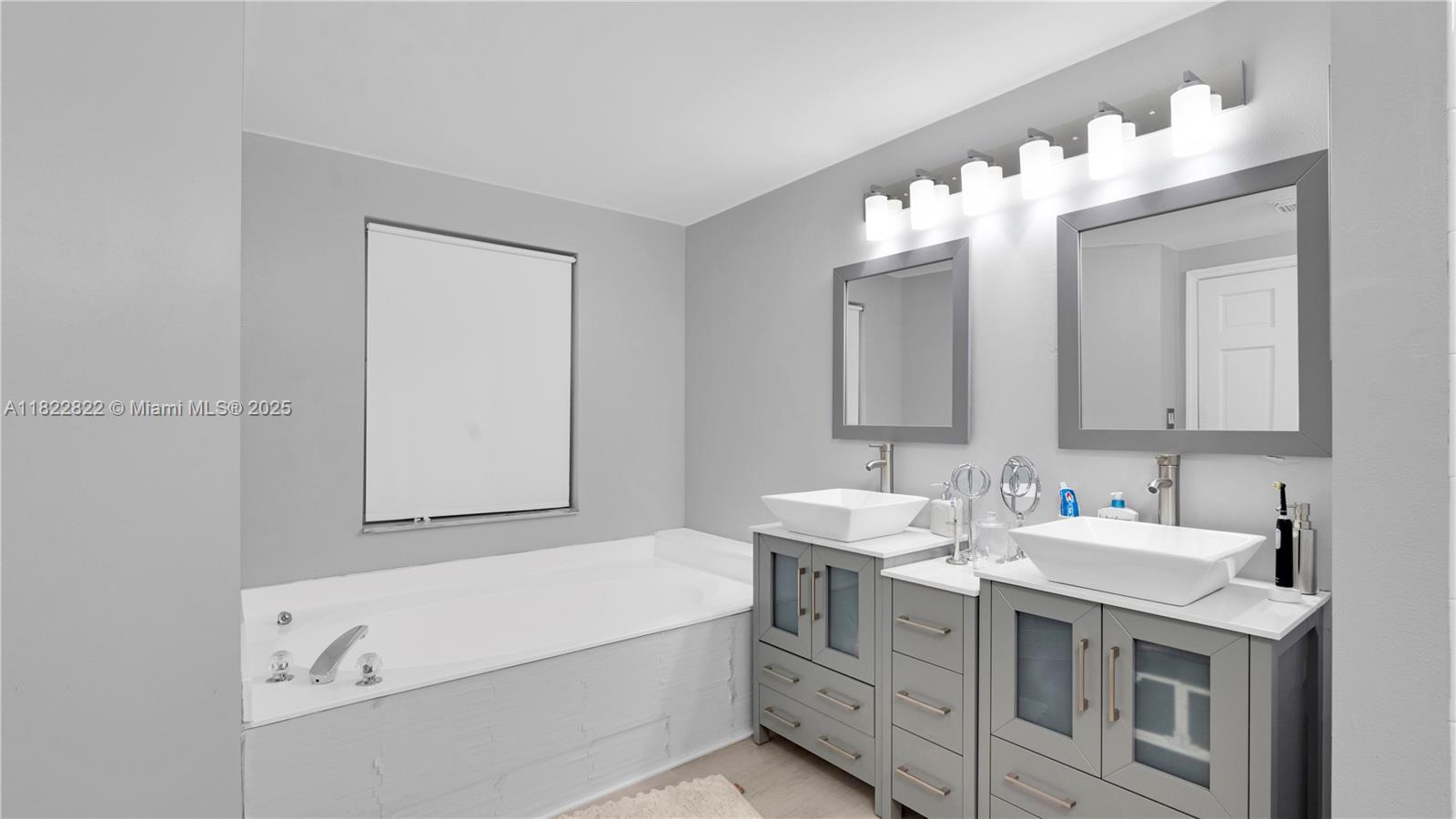 8356 Southwest 158th Avenue Miami, FL 33193 - Photo 24 of 48 a bathroom with a double vanity sink mirror and bathtub