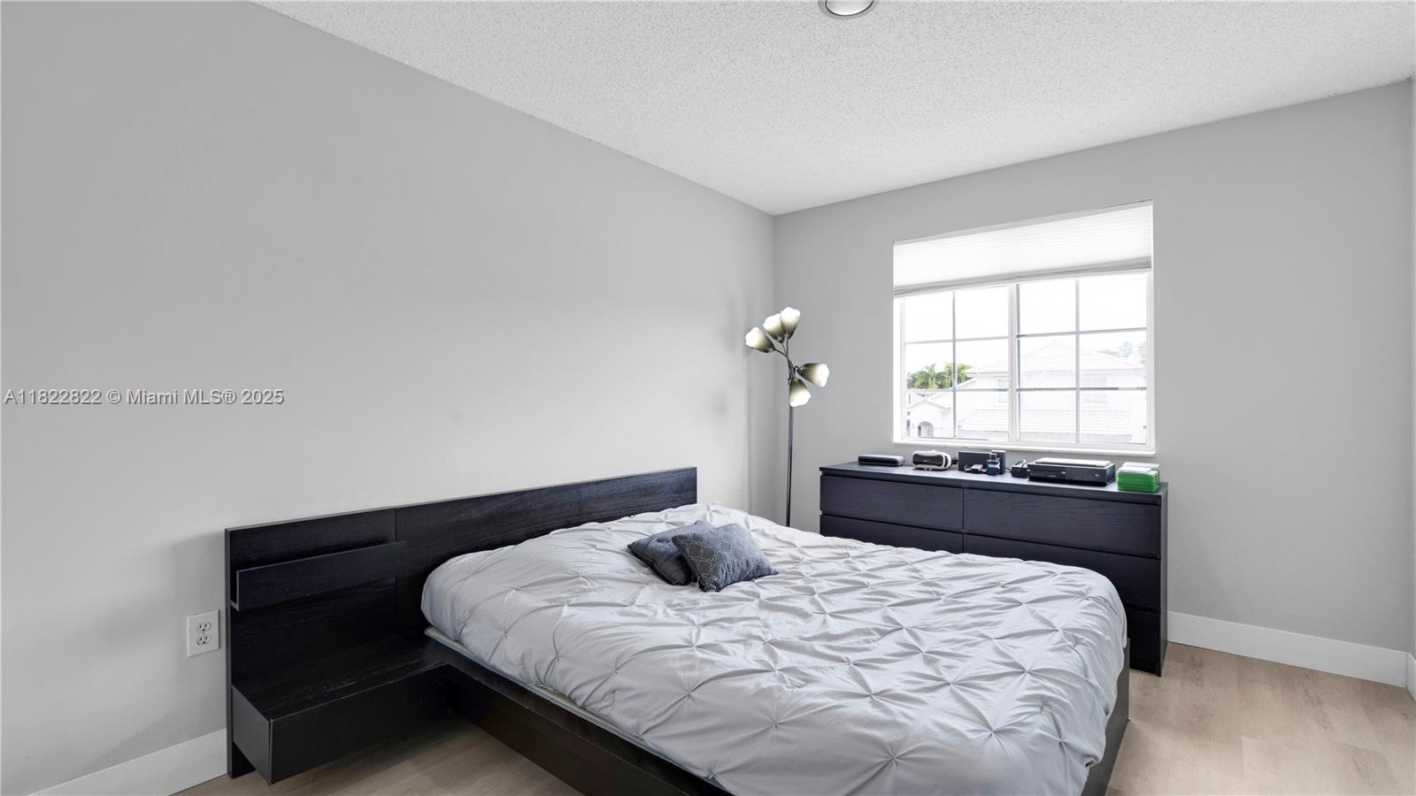 8356 Southwest 158th Avenue Miami, FL 33193 - Photo 34 of 48 a bedroom with a bed and window