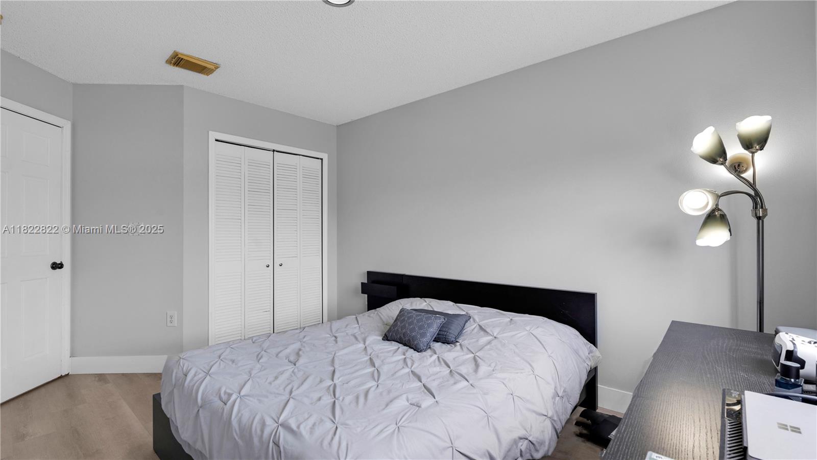 8356 Southwest 158th Avenue Miami, FL 33193 - Photo 36 of 48 a bedroom with a bed and wooden floor