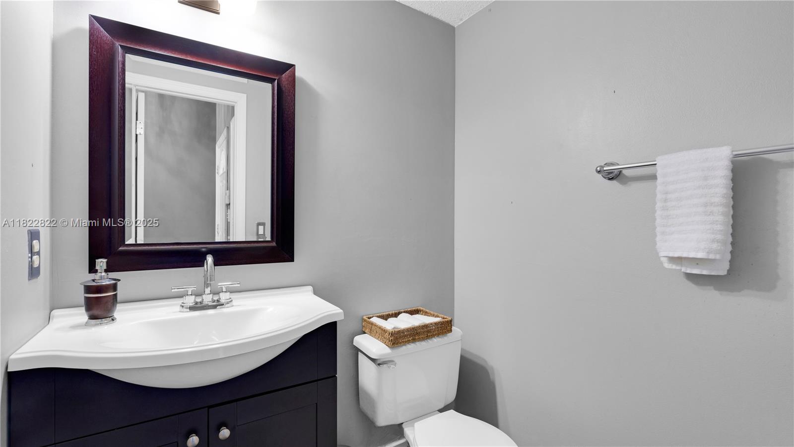 8356 Southwest 158th Avenue Miami, FL 33193 - Photo 37 of 48 a bathroom with a sink vanity mirror and toilet