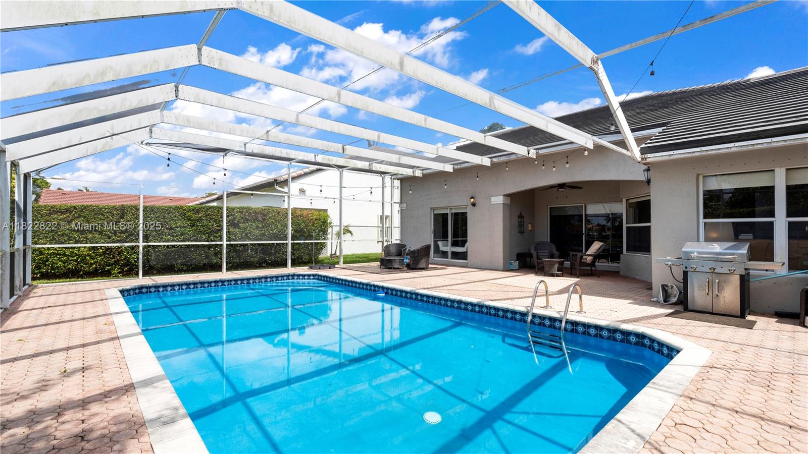 8356 Southwest 158th Avenue Miami, FL 33193 - Photo 40 of 48 a view of a patio with a table and chairs under an umbrella