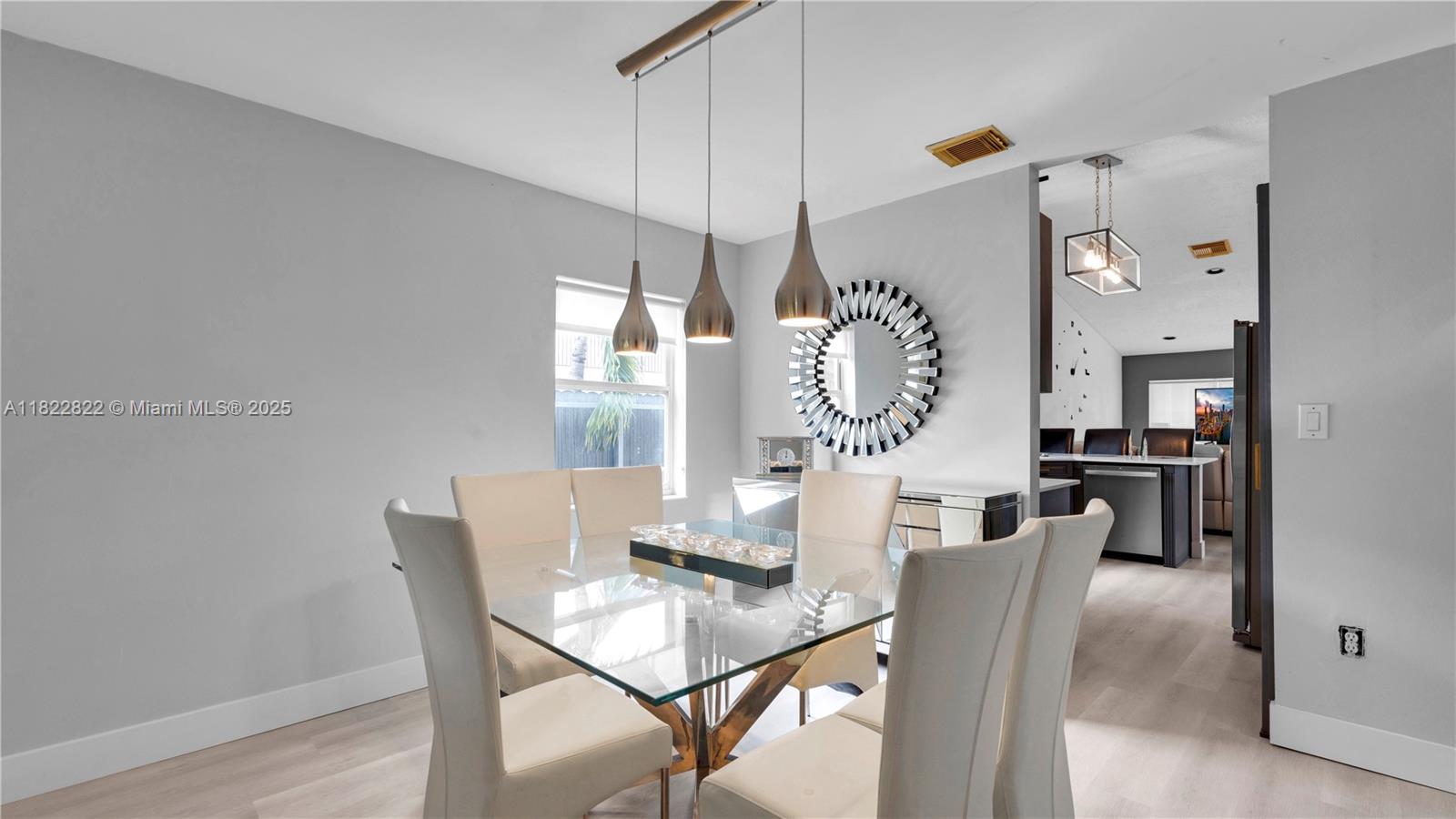 8356 Southwest 158th Avenue Miami, FL 33193 - Photo 10 of 48 a view of a dining room with furniture window and wooden floor