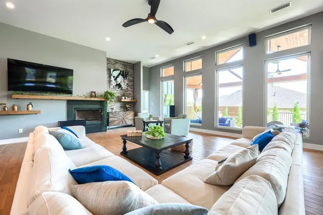 a living room with furniture large window and a flat screen tv