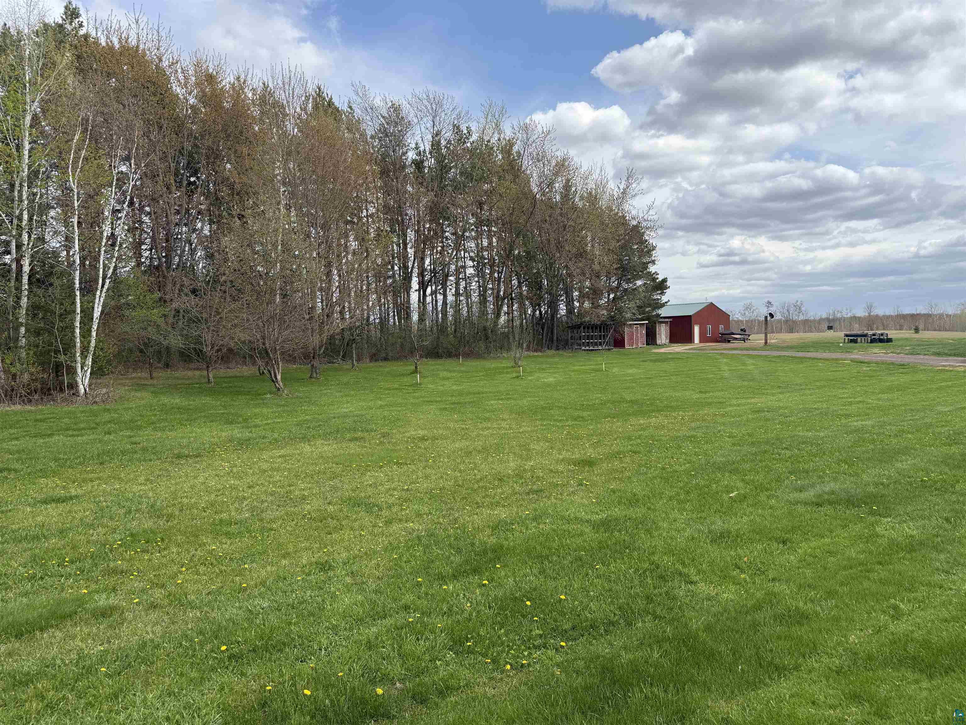 37590 Degerstrom Road Askov, MN 55704 - Photo 39 of 53 Expansive green lawn with mature trees bordering the property