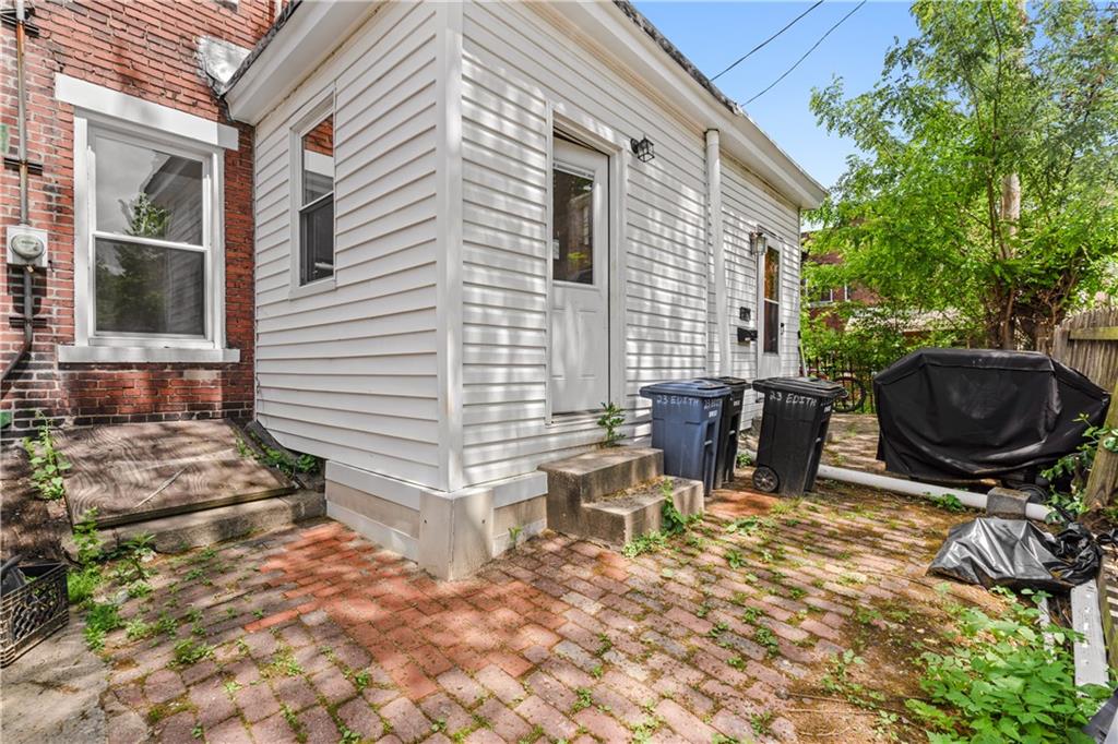23 Edith Place Pittsburgh, PA 15213 - Photo 19 of 23 a view of a patio with table and chairs with wooden fence and plants