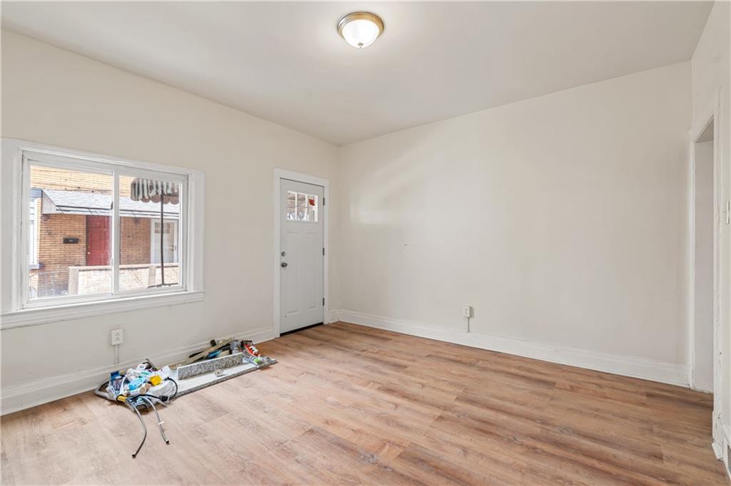 23 Edith Place Pittsburgh, PA 15213 - Photo 3 of 23 an empty room with wooden floor and windows