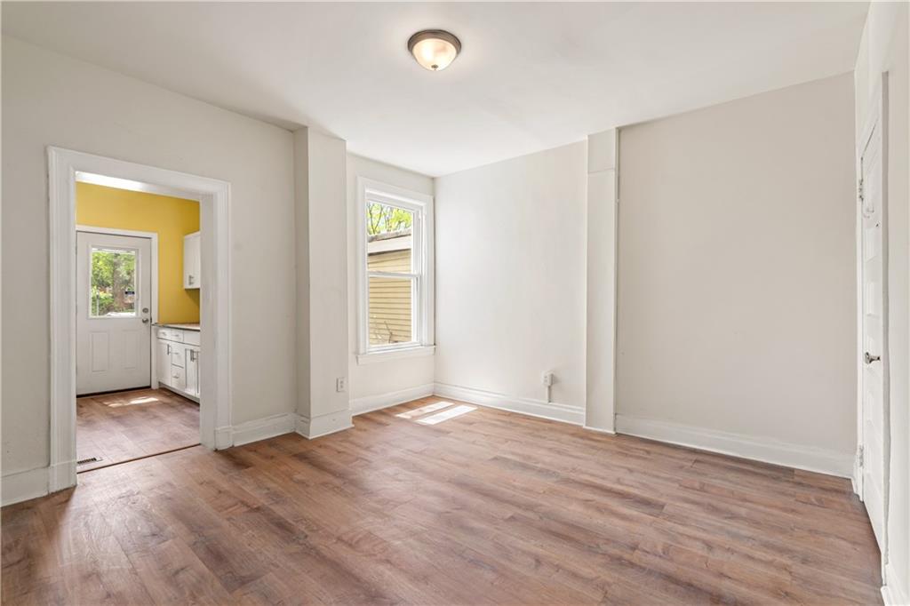23 Edith Place Pittsburgh, PA 15213 - Photo 5 of 23 an empty room with wooden floor and a bathroom