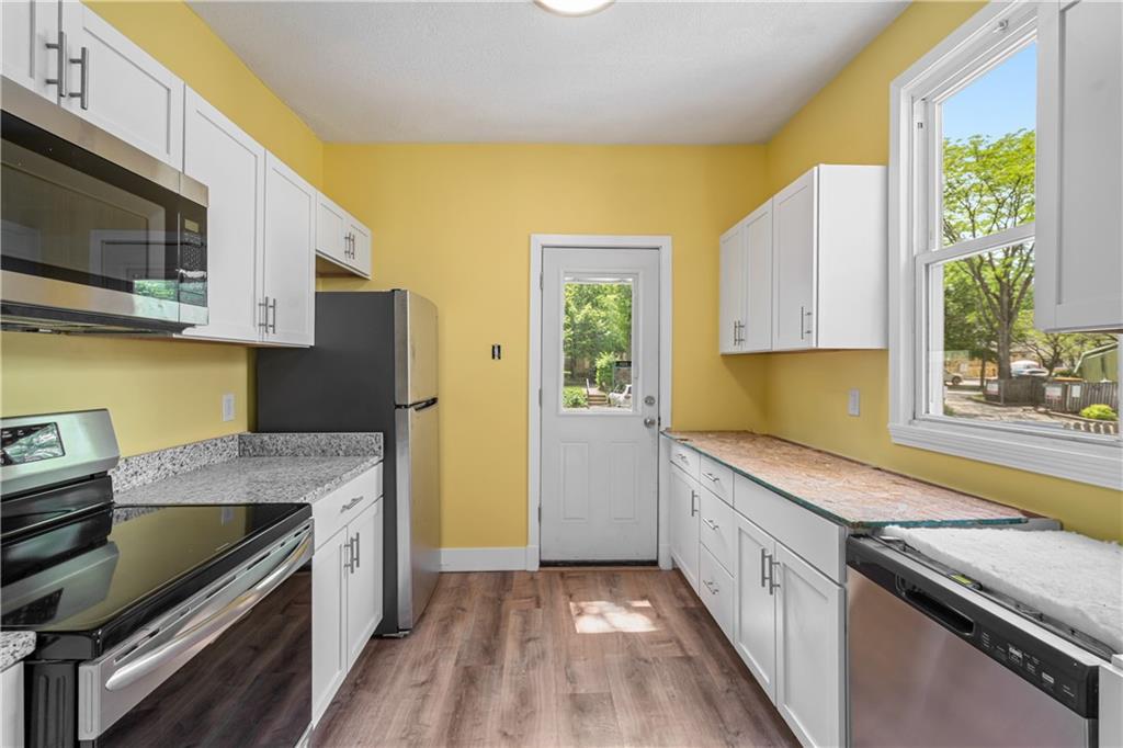 23 Edith Place Pittsburgh, PA 15213 - Photo 7 of 23 a kitchen with stainless steel appliances a stove a sink and a microwave