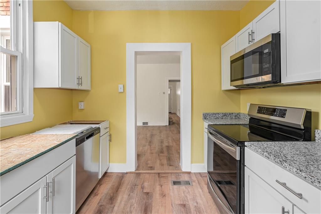23 Edith Place Pittsburgh, PA 15213 - Photo 8 of 23 a kitchen with a sink stove and microwave
