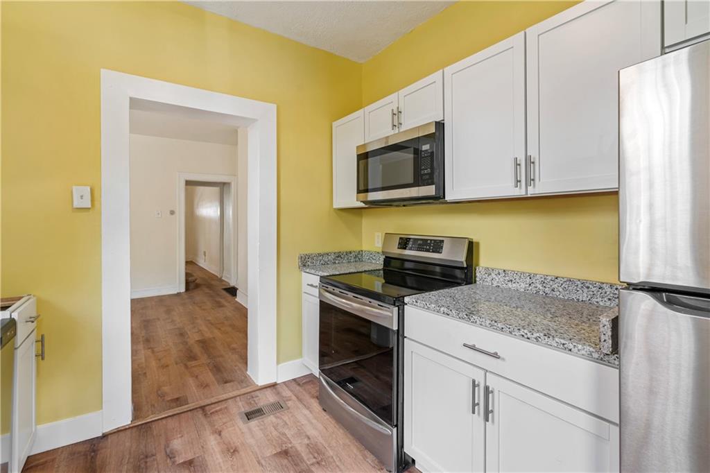 23 Edith Place Pittsburgh, PA 15213 - Photo 9 of 23 a kitchen with a sink stove and microwave