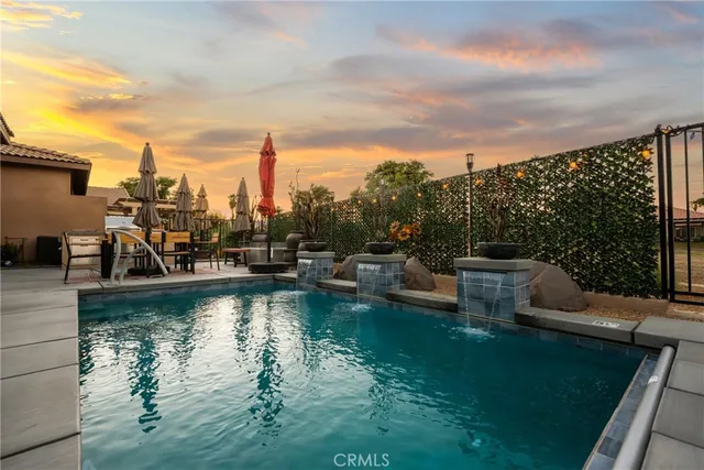 a view of a lake with lawn chairs