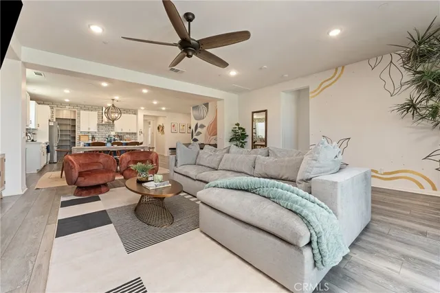 a bedroom with a bed a couch and a flat tv screen