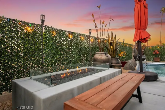 a view of a house with swimming pool and sitting area