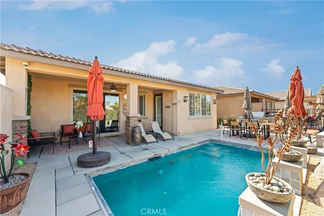 a view of a patio with a table and chairs