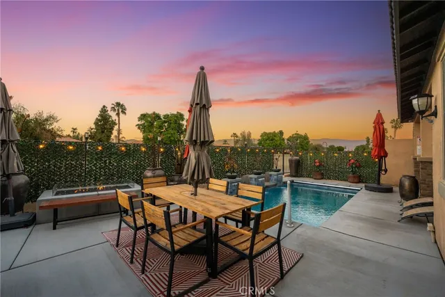 a view of a house with backyard and sitting area