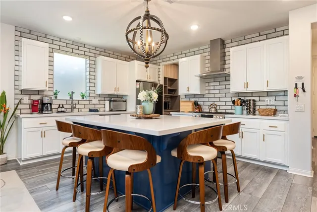 a kitchen with stainless steel appliances granite countertop a stove and a refrigerator