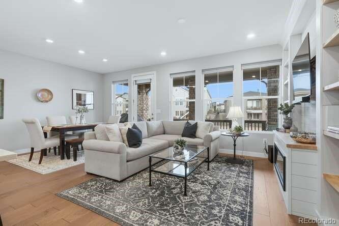 1925 Canyonpoint Place Castle Pines, CO 80108 - Photo 12 of 50 a living room with furniture wooden floor and a table