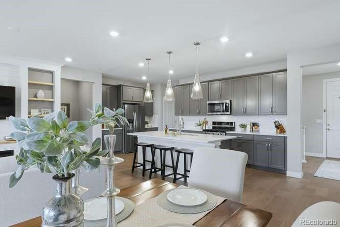 1925 Canyonpoint Place Castle Pines, CO 80108 - Photo 16 of 50 a kitchen with granite countertop a white cabinets stainless steel appliances and couches