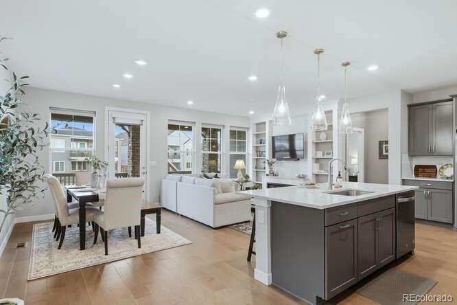 1925 Canyonpoint Place Castle Pines, CO 80108 - Photo 2 of 50 a large white kitchen with a large island in the center