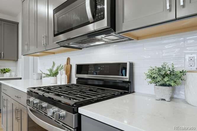 1925 Canyonpoint Place Castle Pines, CO 80108 - Photo 21 of 50 a stove top oven sitting inside of a kitchen