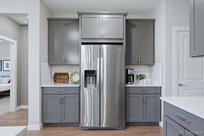 1925 Canyonpoint Place Castle Pines, CO 80108 - Photo 22 of 50 a kitchen with a refrigerator and cabinets