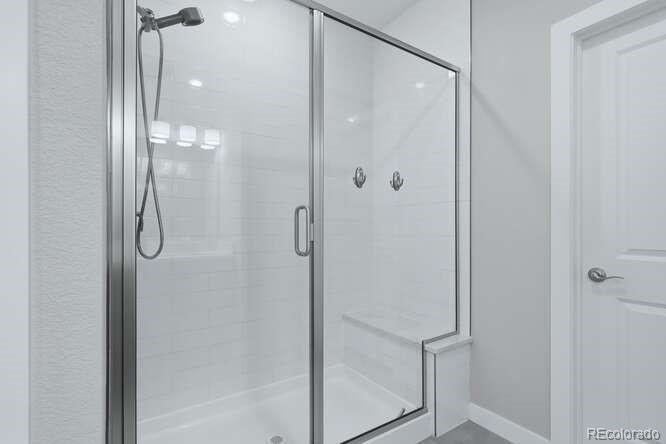 1925 Canyonpoint Place Castle Pines, CO 80108 - Photo 26 of 50 a bathroom with a glass shower door