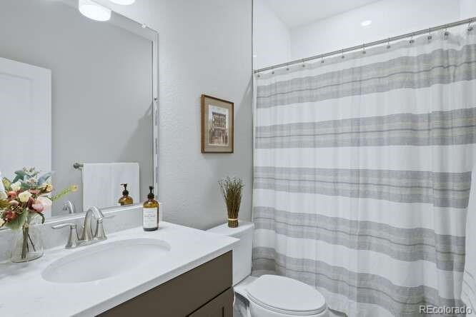 1925 Canyonpoint Place Castle Pines, CO 80108 - Photo 27 of 50 a bathroom with a sink toilet and shower