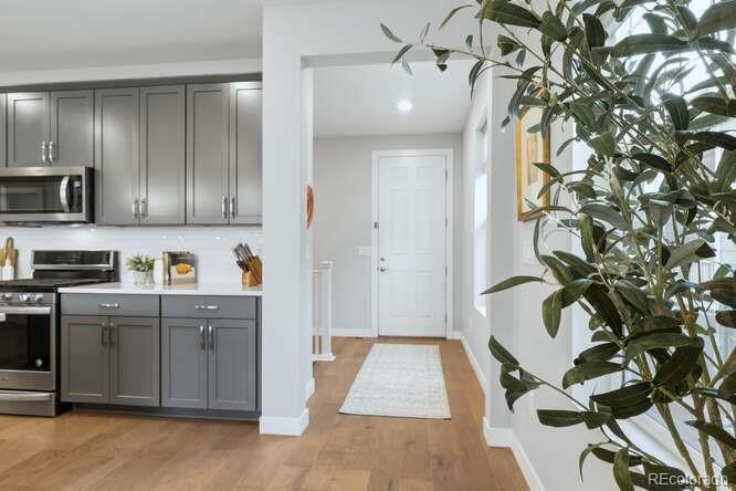 1925 Canyonpoint Place Castle Pines, CO 80108 - Photo 3 of 50 a kitchen with stainless steel appliances kitchen island granite countertop a refrigerator and a sink