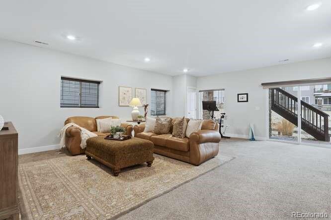 1925 Canyonpoint Place Castle Pines, CO 80108 - Photo 31 of 50 a living room with furniture and a couch