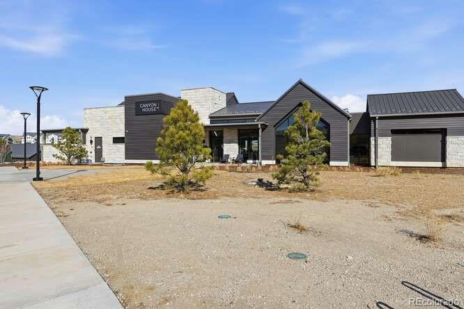 1925 Canyonpoint Place Castle Pines, CO 80108 - Photo 49 of 50 a view of a house with snow on the road