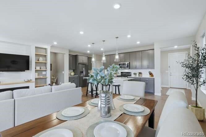 1925 Canyonpoint Place Castle Pines, CO 80108 - Photo 8 of 50 a dining room with furniture a rug and a kitchen