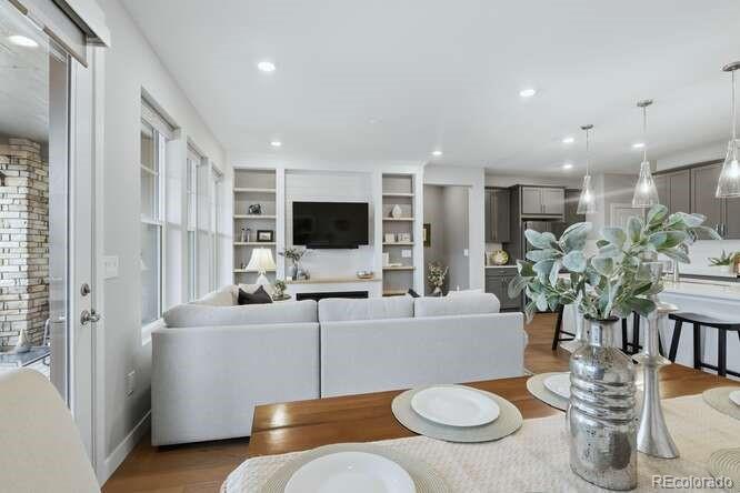 1925 Canyonpoint Place Castle Pines, CO 80108 - Photo 9 of 50 a living room with furniture and a flat screen tv