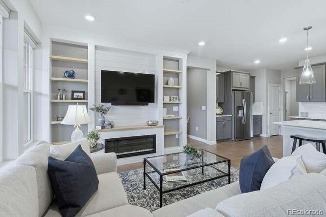 1925 Canyonpoint Place Castle Pines, CO 80108 - Photo 10 of 50 a living room with furniture and a flat screen tv