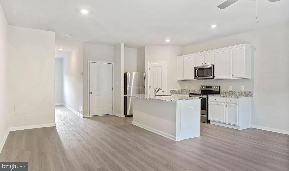 58 Cramsford Street Falling Waters, WV 25419 - Photo 4 of 9 a kitchen with a refrigerator and a stove top oven