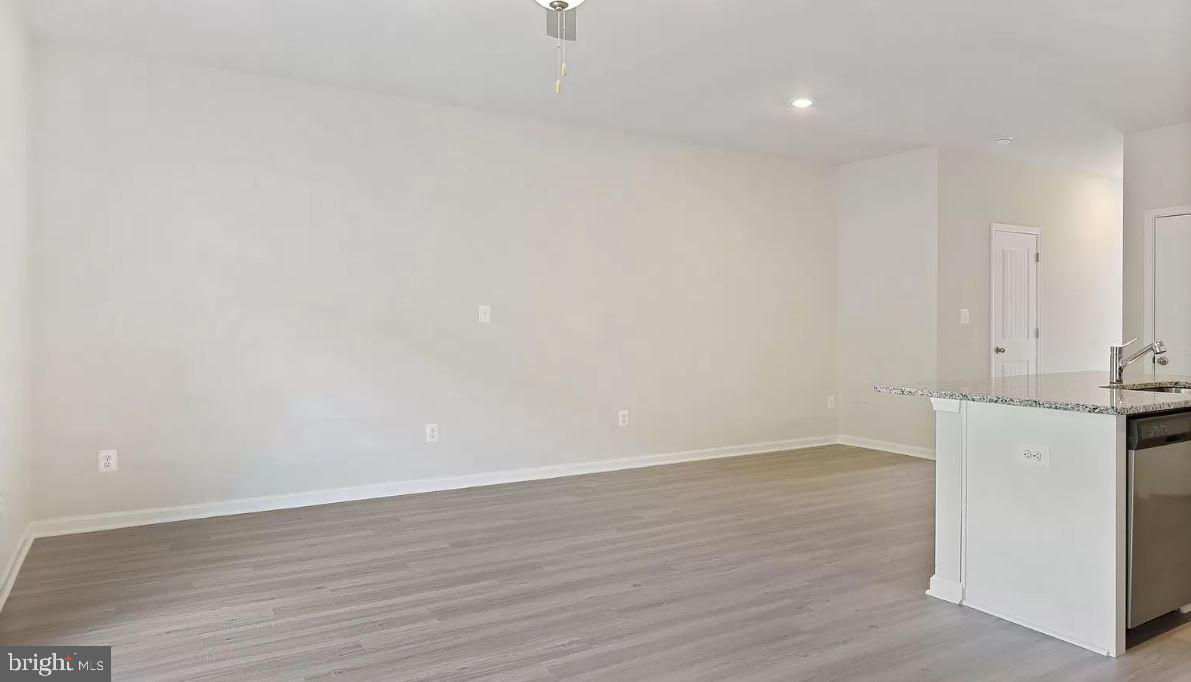 58 Cramsford Street Falling Waters, WV 25419 - Photo 5 of 9 a view of an empty room with wooden floor