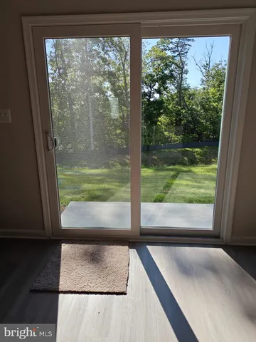 a view of a room with a large window and front door