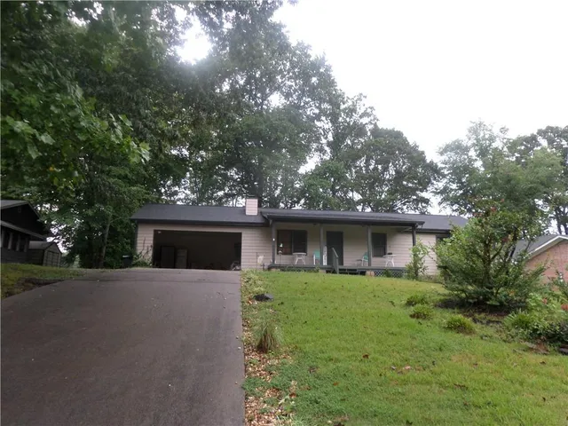 a front view of house with yard and green space