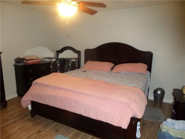 a bedroom with a bed and dresser