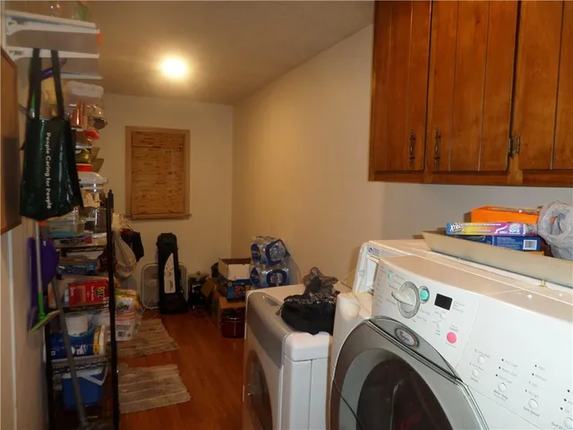 a utility room with dryer washer and other items