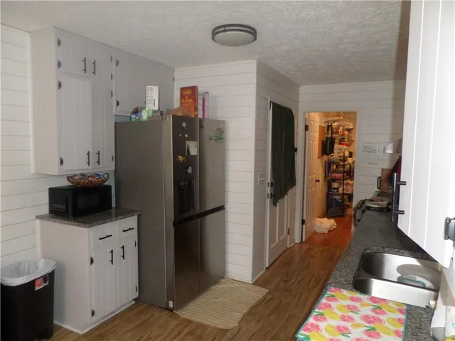 a kitchen with a refrigerator and a sink