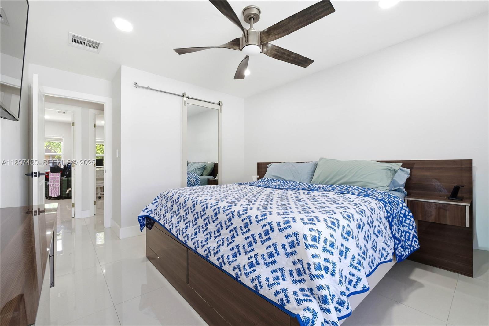 13765 Southwest 54th Lane Miami, FL 33175 - Photo 18 of 30 a bedroom with double bed and a chandelier