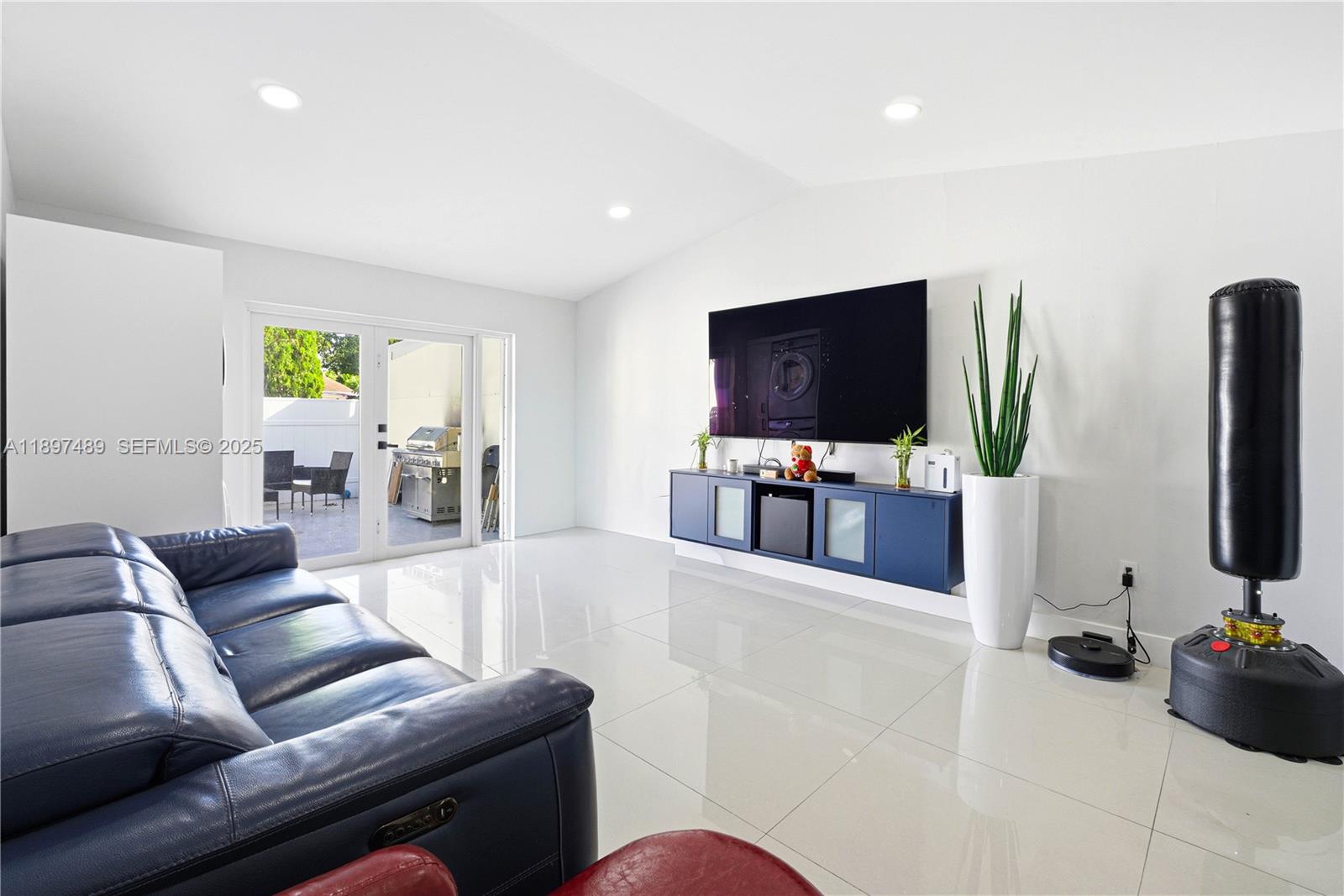 13765 Southwest 54th Lane Miami, FL 33175 - Photo 3 of 30 a living room with furniture and a flat screen tv