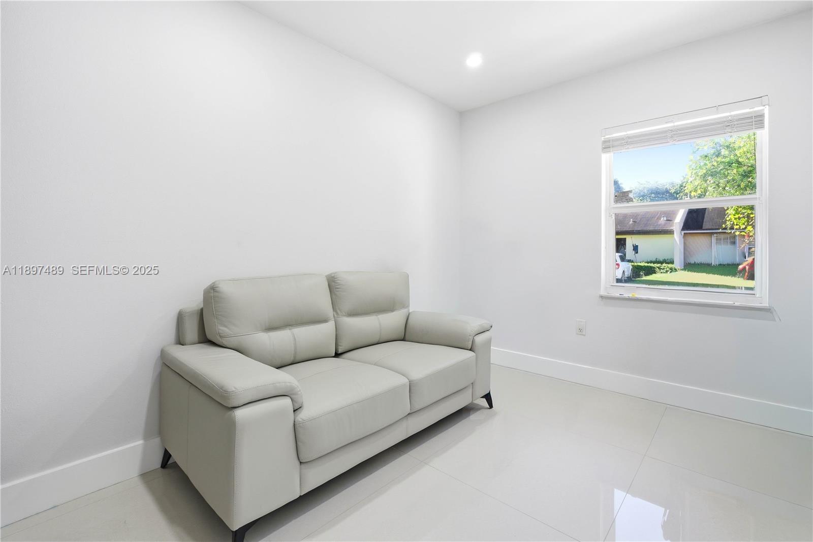 13765 Southwest 54th Lane Miami, FL 33175 - Photo 6 of 30 a living room with furniture and a window