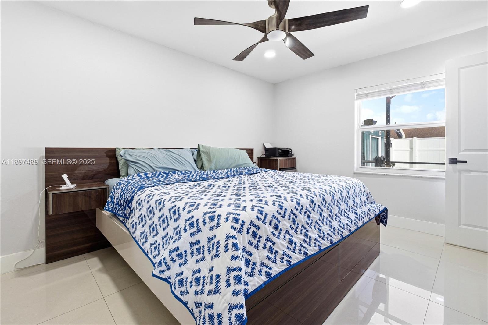13765 Southwest 54th Lane Miami, FL 33175 - Photo 7 of 30 a bedroom with a large bed and a chandelier